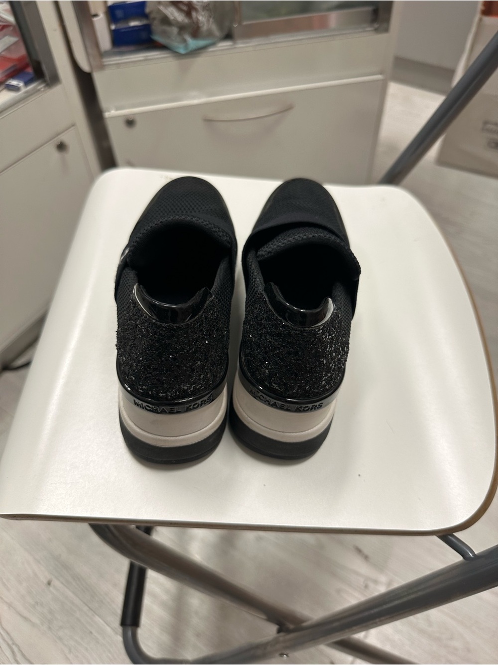Michael Kors women Black Glitter Slip-On Sneakers with Silver Accents